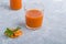 Nutritious detox carrot juice in glass and leaves of parsley. Alkaline diet concept. Organic vegetarian drink. Healthy eating.