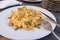 Nutritious dish of Scrambled eggs with ham and pepper for brunch on a restaurant. Lunch healthy menu meal with egg and vegetable,