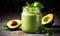 Nutritious green smoothie in glass jar with spinach leaves, half avocado, and chia seeds on grey backdrop - a healthful vegan