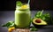 Nutritious green smoothie in glass jar with spinach leaves, half avocado, and chia seeds on grey backdrop - a healthful vegan
