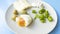 A nutritious, nutritious breakfast consisting of boiled eggs, fresh cheddar cheese, green olives, peppers and cottage cheese.