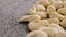 Nutritious raw cashew nuts on a textured surface close up.