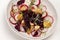Nutritious salad of sliced boiled beets, sliced radish and apples with young microgreen sprouts