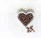 Nuts arranged in heart shape on background. Food image close up candy, chocolate milk, extra dark almond nuts. Love Texture on