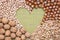 Nuts background, texture. Various type of nut in form of heart. Walnut, hazelnut, almond, pistachio, top view, flat lay