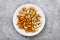 Nuts for beer in a white ceramic plate