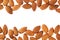 Nuts border of almonds on white background. Pile of selected almond close-up.