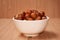 Nuts in a bowl on a wooden background, Brown nuts. Nuts.Side vie