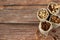 Nuts in rustic bags on wooden background with copy space, top view