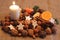 Nuts, sweets, fruits, bisquits and white candle