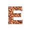 Nuts vitamins alphabet. Letter E made of almonds and paper cut isolated on white. Typeface and healthy food