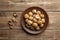 Nuts. Walnut kernels and whole walnuts on a table. Wooden background.