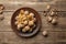 Nuts. Walnut kernels and whole walnuts on a table. Wooden background.