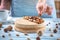 Nutty caramel cheesecake with topping of walnut, almond, hazelnut and macadamia on a wooden background