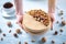 Nutty caramel cheesecake with topping of walnut, almond, hazelnut and macadamia on a wooden background