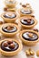 Nutty chocolate dessert small tarts on a white background