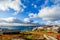 Nuuk city old harbor fjord panorama with clouds over the blue sk