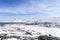 Nuuk city suburb at the fjord, snow landscape with blue sky and