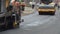 NYC, USA - May 20 2021: Constructions Workers Working on Road. Team of workers put the hot asphalt. Repair highway