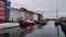 Nyhavn canal with floating tour boat which full of tourists and background of colourful iconic townhouses.