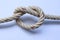 Nylon marine ropes tied to knot isolated on white background closeup.