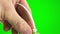 nylon tie On a green background, a chromakey man fastens a nylon tie with his own hands. He pulls the long end through