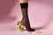 Nylons, stay-up, tights, hosiery, hose, pantyhose socks summer collection on pink background as a heel creative a glass of