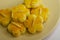 Nyonya almond cookies, piped into flower shapes, on a white saucer