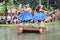 Oahu, Hawaii - 4/26/2018 - Hawaiian dancers performing while riding a canoe float at the Polynesian Cultural Center in Hawaii