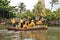 Oahu, Hawaii - 4/26/2018 - Hawaiian dancers performing while riding a canoe float at the Polynesian Cultural Center in Hawaii