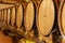 Oak barrels with different types of wine in Italian winery, tasting and sale of wine