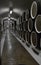 Oak barrels lie in rows in the wine cellar, storage and aging of wine