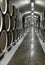 Oak barrels lie in rows in the wine cellar, storage and aging of wine