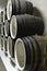 Oak barrels lie in rows in the wine cellar, storage and aging of wine