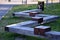 Oak gray wood without impregnation wood on the terrace is folded and connected by steel clips like a park bench. the bench include