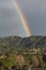 Oak View, California, USA, March 1, 2015, full rainbow over rain storm over mountains Ojai Valley