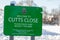 OAKHAM, RUTLAND, ENGLAND- 25 JANUARY 2021: Cutts Close park entrance sign, with a child sledging in the background, on a snowy day