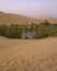 The oasis town of Huacachina as seen from the sand dune at sunset, Ica region, Peru, South America