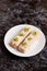 Oat bar with coconut with mint on a plate, close up, top view