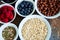 Oat berries superfood seeds in bowls on a rusty background