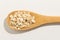 Oat cereal grain. Nutritious grains on a wooden spoon on white b