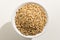 Oat cereal grain. Top view of grains in a bowl. White background