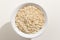 Oat cereal grain. Top view of grains in a bowl. White background