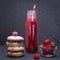 Oat cookies with raspberry, soft cheese, honey and raw raspberry and red juice on the background of black slate , close up