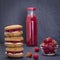 Oat cookies with raspberry, soft cheese, honey and raw raspberry and red juice on the background of black slate , close up