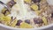 In oat and corn flakes with dried fruits pour milk slow motion