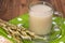 Oat decoction in a transparent mug, grains and ears