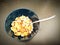 Oat flakes in a blue cup accompanied by a spoon to enjoy breakfast.