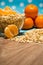 Oat flakes scattered on the table and in a glass bowl and tangerines