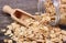 Oat flakes spilling out of jar on wooden background